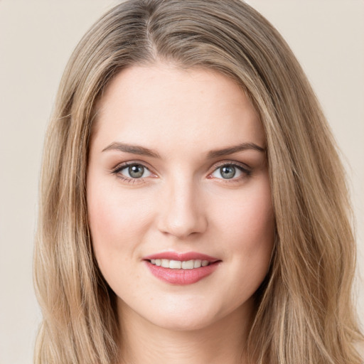 Joyful white young-adult female with long  brown hair and green eyes