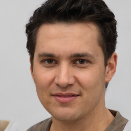 Joyful white adult male with short  brown hair and brown eyes