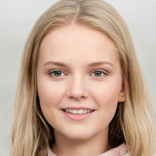 Joyful white young-adult female with long  brown hair and blue eyes