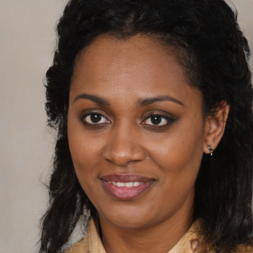 Joyful black young-adult female with medium  black hair and brown eyes