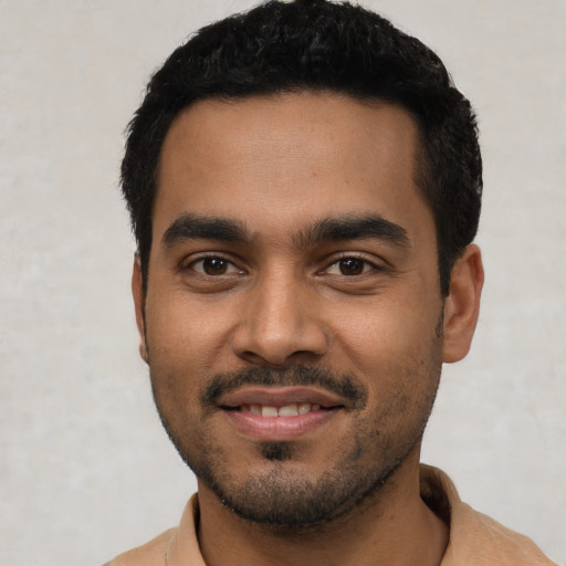 Joyful latino young-adult male with short  black hair and brown eyes