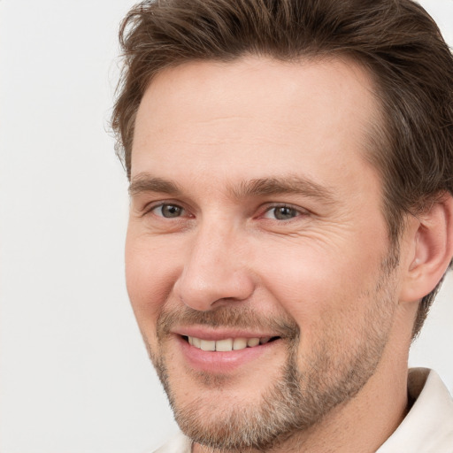 Joyful white adult male with short  brown hair and brown eyes