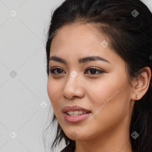 Joyful latino young-adult female with long  brown hair and brown eyes