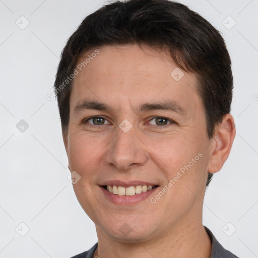 Joyful white young-adult male with short  brown hair and brown eyes