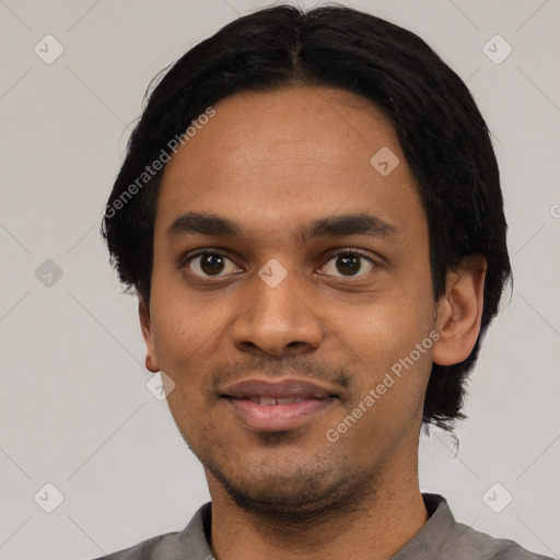 Joyful black young-adult male with short  black hair and brown eyes