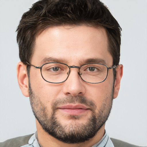 Joyful white adult male with short  brown hair and brown eyes