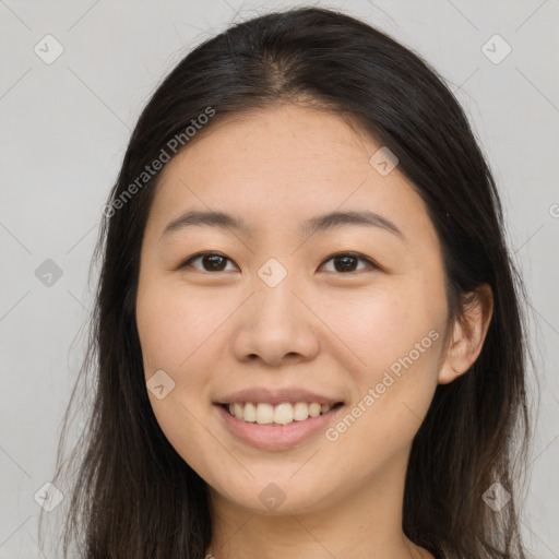 Joyful asian young-adult female with long  brown hair and brown eyes