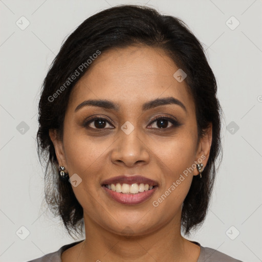 Joyful latino young-adult female with medium  brown hair and brown eyes