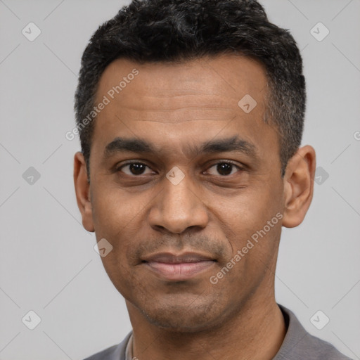 Joyful latino adult male with short  black hair and brown eyes