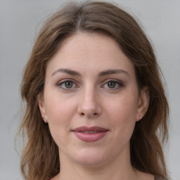 Joyful white young-adult female with long  brown hair and green eyes