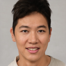 Joyful asian young-adult male with short  brown hair and brown eyes