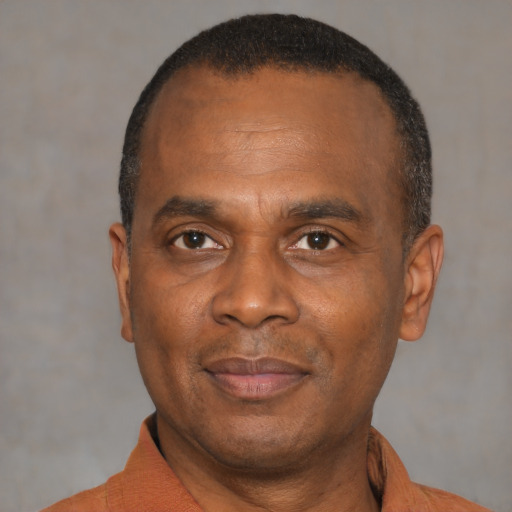 Joyful latino adult male with short  black hair and brown eyes