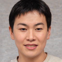 Joyful asian young-adult male with short  brown hair and brown eyes