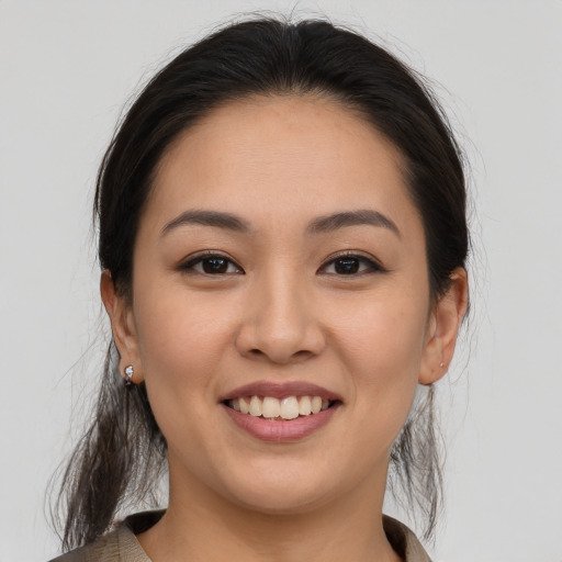 Joyful white young-adult female with medium  brown hair and brown eyes