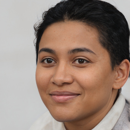 Joyful latino young-adult female with short  brown hair and brown eyes