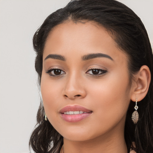 Joyful latino young-adult female with long  brown hair and brown eyes