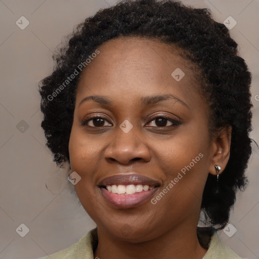 Joyful black young-adult female with long  brown hair and brown eyes