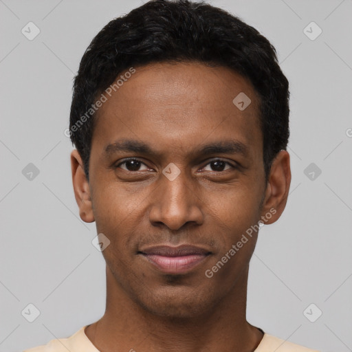 Joyful black young-adult male with short  black hair and brown eyes