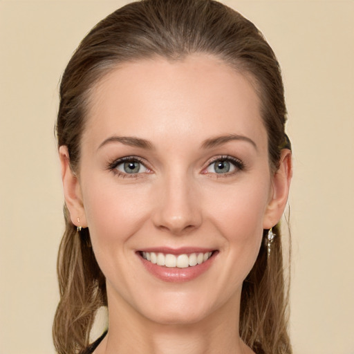 Joyful white young-adult female with long  brown hair and green eyes