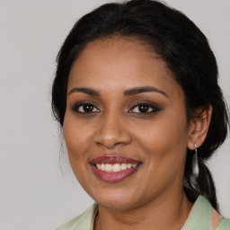 Joyful black young-adult female with medium  brown hair and brown eyes