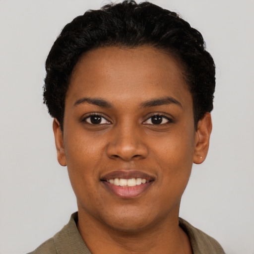 Joyful black young-adult female with short  black hair and brown eyes