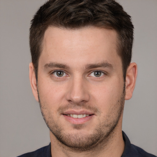 Joyful white young-adult male with short  brown hair and brown eyes