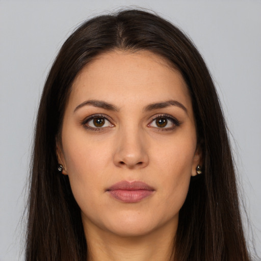 Joyful white young-adult female with long  brown hair and brown eyes