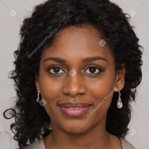 Joyful black young-adult female with long  black hair and brown eyes