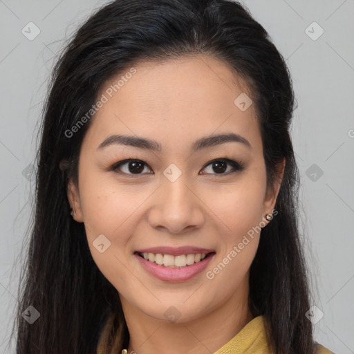 Joyful latino young-adult female with long  brown hair and brown eyes