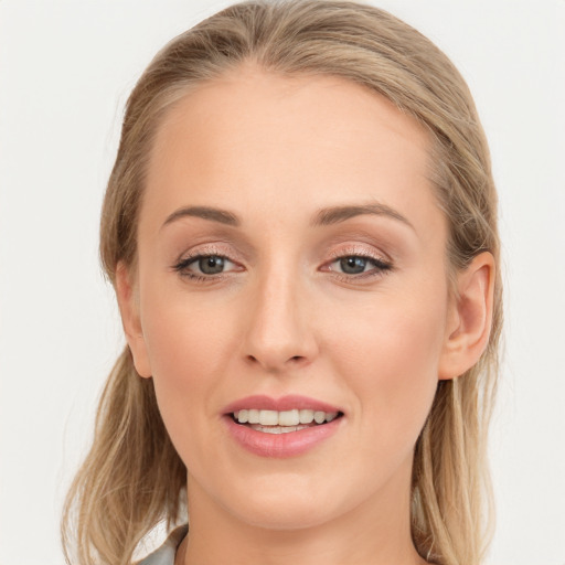 Joyful white young-adult female with long  brown hair and blue eyes