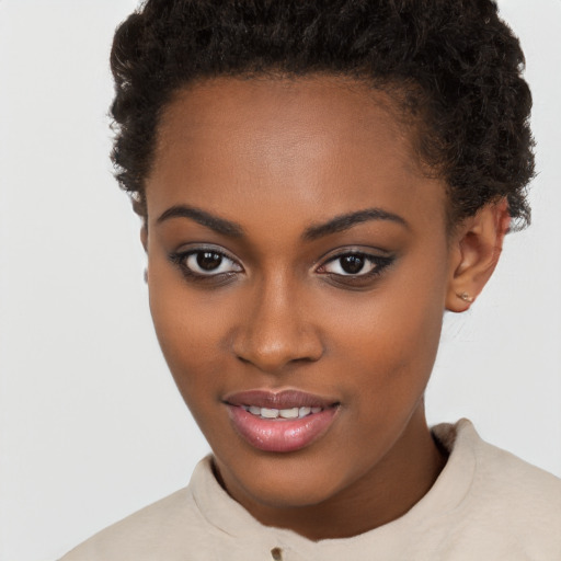 Joyful black young-adult female with short  brown hair and brown eyes