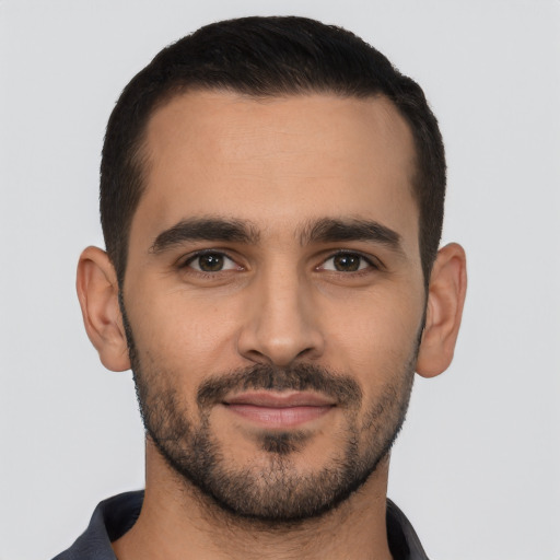 Joyful latino young-adult male with short  black hair and brown eyes