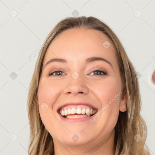 Joyful white young-adult female with long  brown hair and blue eyes