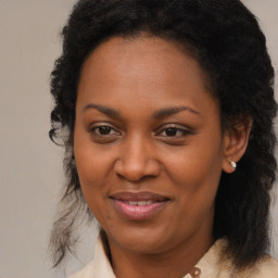 Joyful black adult female with medium  brown hair and brown eyes