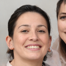 Joyful white adult female with medium  brown hair and brown eyes