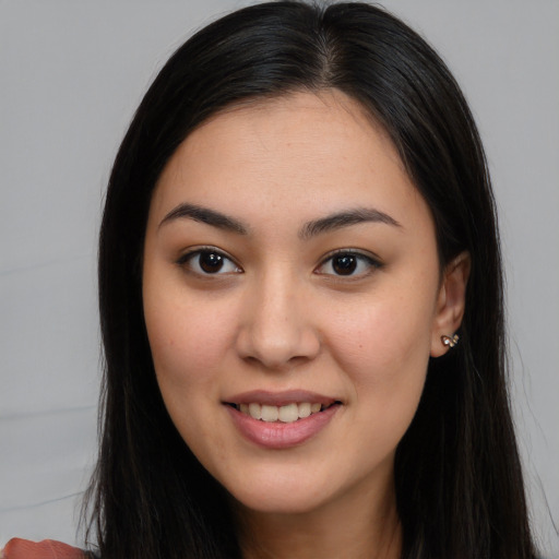 Joyful asian young-adult female with long  brown hair and brown eyes