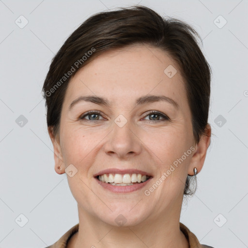 Joyful white young-adult female with short  brown hair and grey eyes