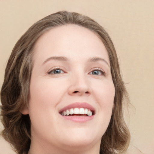 Joyful white young-adult female with medium  brown hair and green eyes