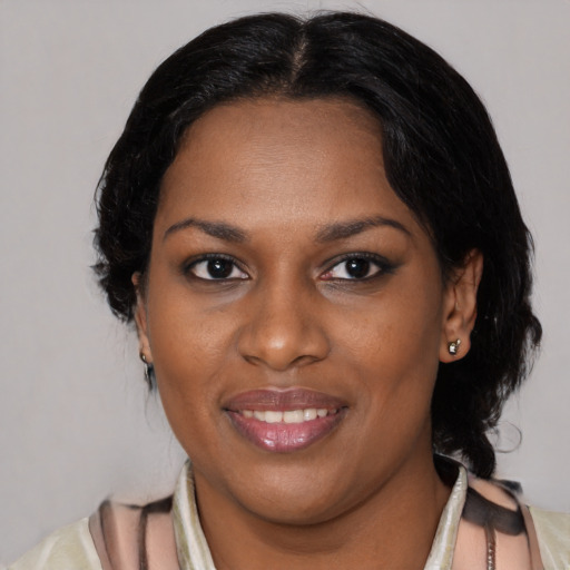 Joyful black young-adult female with medium  black hair and brown eyes