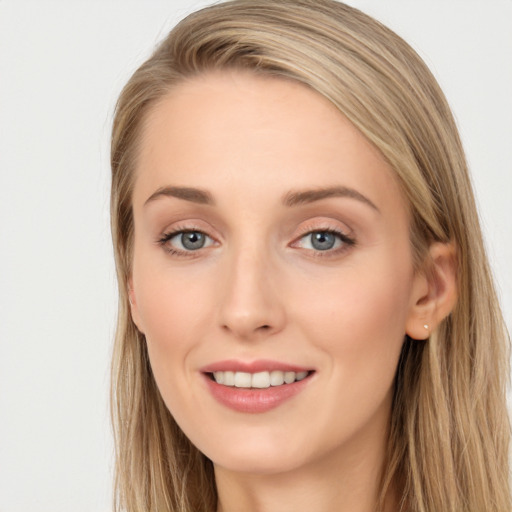 Joyful white young-adult female with long  brown hair and blue eyes