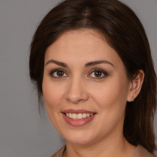 Joyful white young-adult female with medium  brown hair and brown eyes