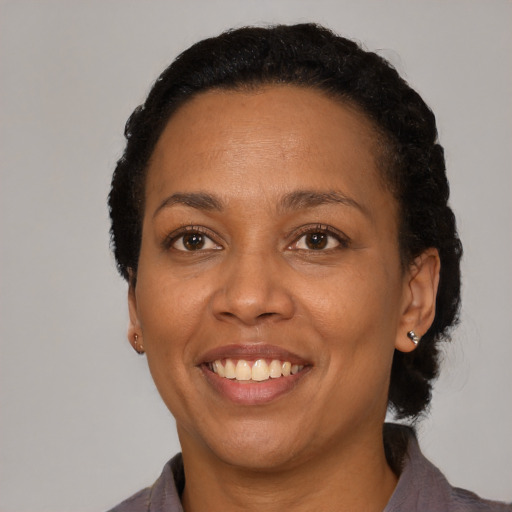 Joyful latino adult female with short  black hair and brown eyes