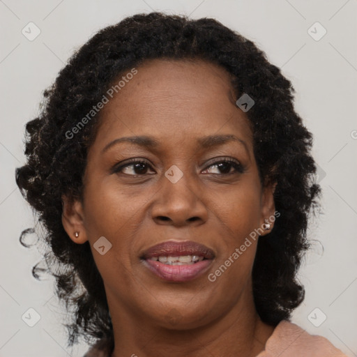 Joyful black adult female with long  brown hair and brown eyes