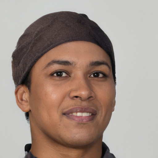 Joyful latino young-adult male with short  brown hair and brown eyes