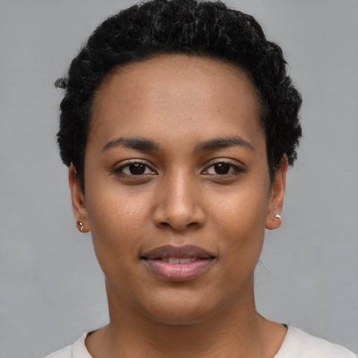 Joyful latino young-adult female with short  black hair and brown eyes