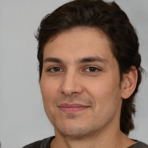 Joyful white young-adult male with medium  brown hair and brown eyes