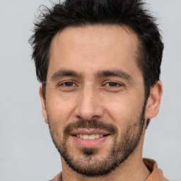 Joyful white adult male with short  brown hair and brown eyes