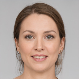 Joyful white young-adult female with medium  brown hair and grey eyes