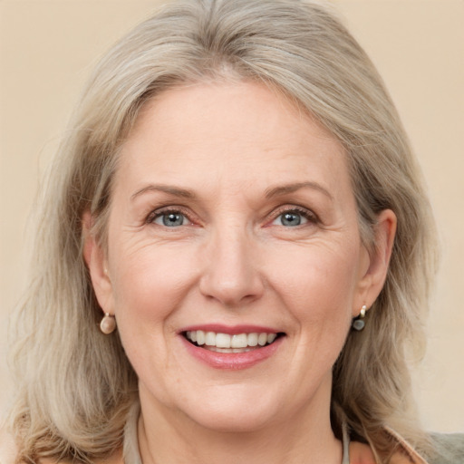 Joyful white adult female with medium  brown hair and grey eyes