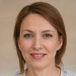 Joyful white young-adult female with medium  brown hair and grey eyes